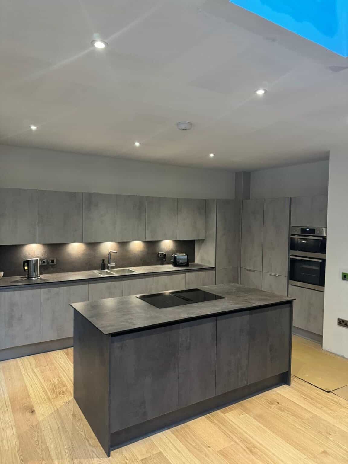 Builder reviewing project details in a renovated kitchen