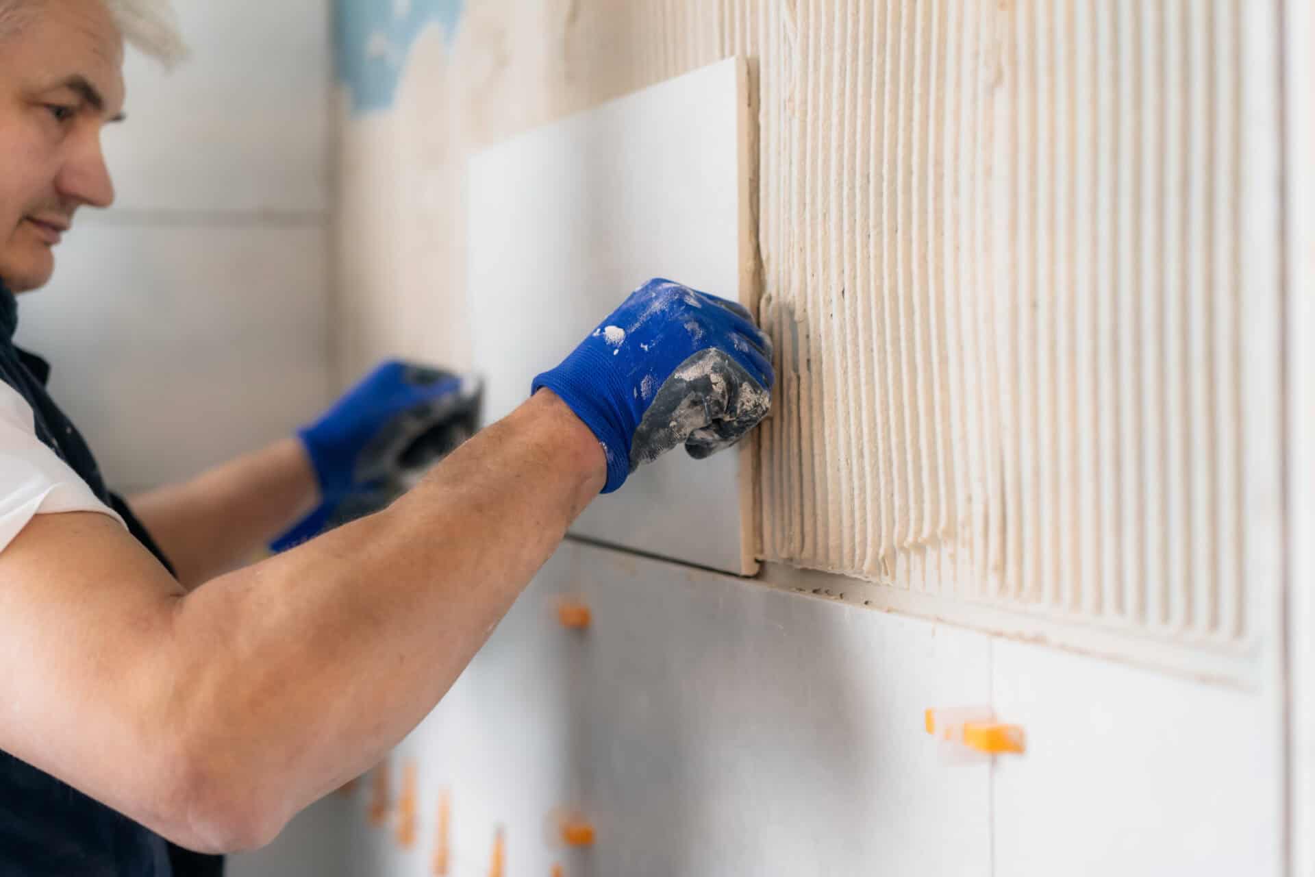 Bathroom wall tiling during property renovation